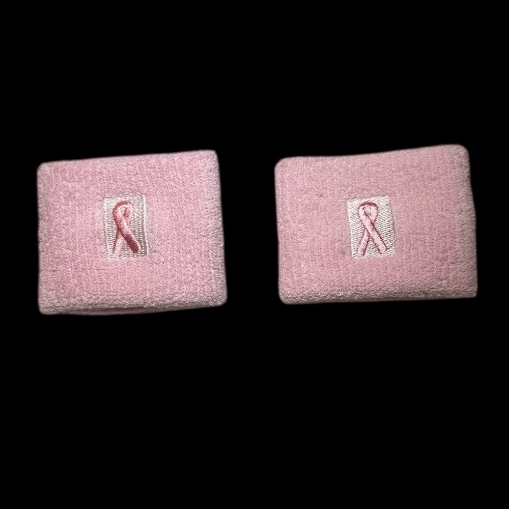 Pair of pink terry cloth breast cancer awareness sweatband wristbands